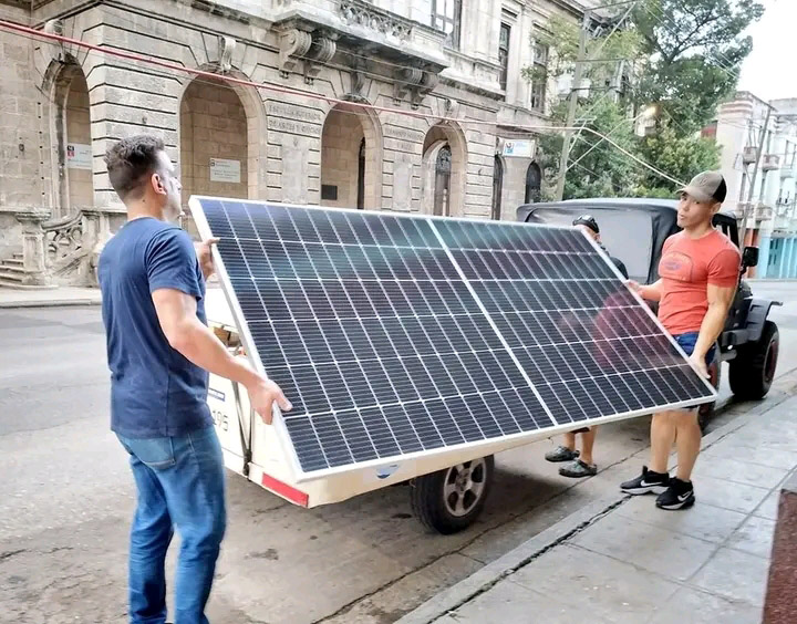 trabajadores de Lucendi que sostienen panel solar